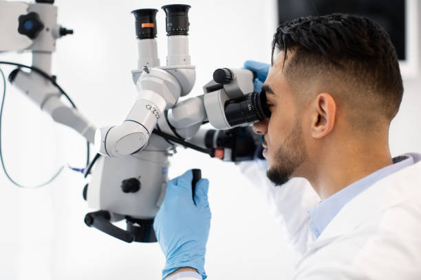 istock Modern Technologies For Healthcare. Arab Doctor Using Dental Microscope In Clinic 1368566234