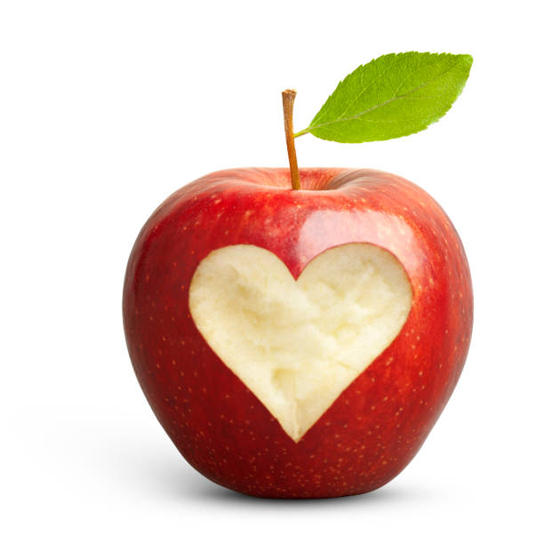istock Red apple with heart on white background 1368568203