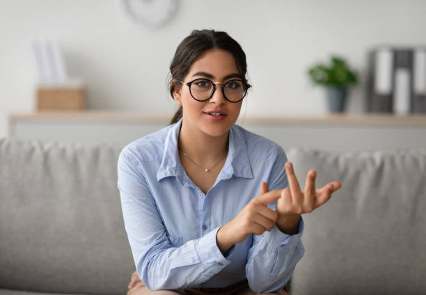 istock Professional female psychologist talking to camera and gesturing during therapy session at clinic, working at office 1368568289