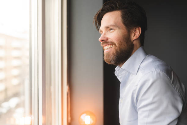istock Man at home waiting by the window 1368569299