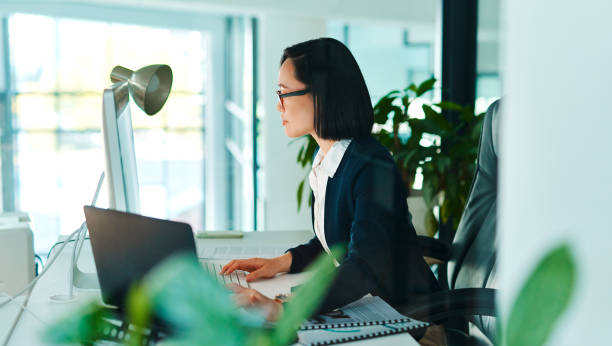 istock Shot of a young businesswoman using a computer in a modern office at work 1368572445