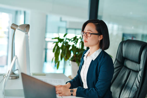 istock Shot of a young businesswoman using a computer in a modern office at work 1368572452