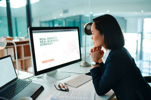 Shot of a young businesswoman using a computer in a modern office at work