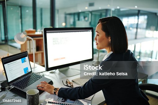 istock Shot of a young businesswoman using a computer in a modern office at work 1368572465