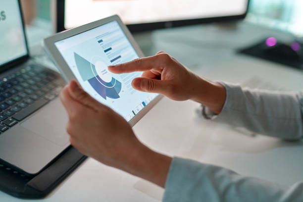istock Shot of an unrecognizable businessperson using a digital tablet at work 1368572478