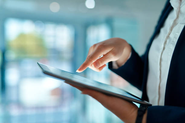 istock Shot of an unrecognizable businessperson using a digital tablet at work 1368572483