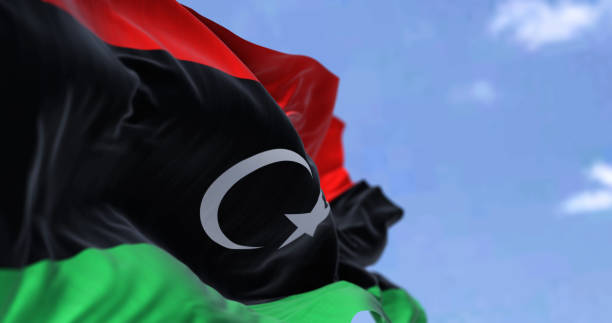 detalle de la bandera nacional de libia ondeando al viento en un día despejado - libyan flag fotografías e imágenes de stock