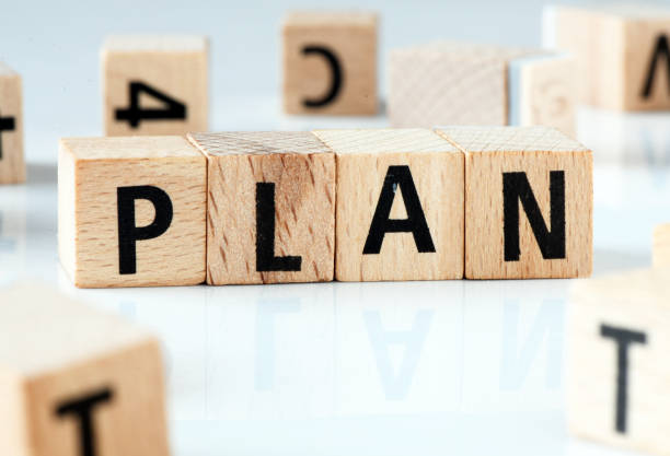 istock PLAN word arranged with wooden letters on a white background. 1368572638