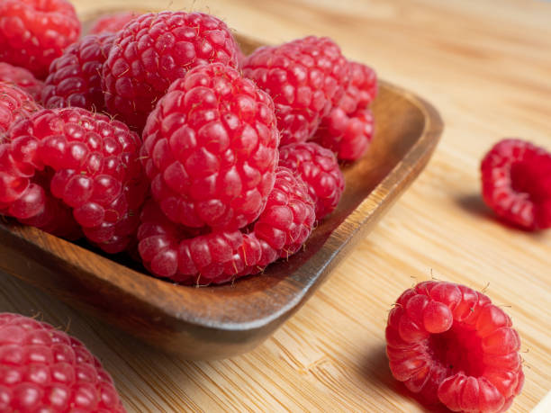 istock Raspberries in a wooden bowl 1368576772
