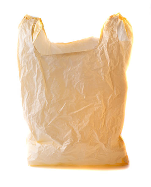 istock Plastic yellow bag empty. Plastic bags are the cause of major environmental concerns. Object is isolated on white isolated background without shadows 1368577656