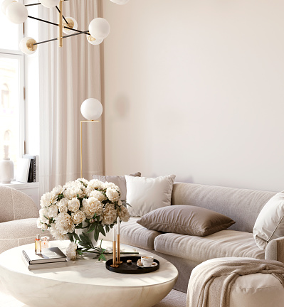 Living room interior in light beige color with a soft sofa, a marble table and a pouffe against an empty wall. Side view. 3D rendering, 3d illustration