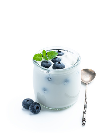 White  creamy yogurt with fresh blueberry in small jar isolated on white