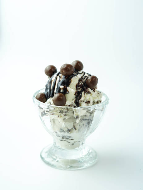istock Scoops of ice cream with chocolate balls and syrup 1368581080