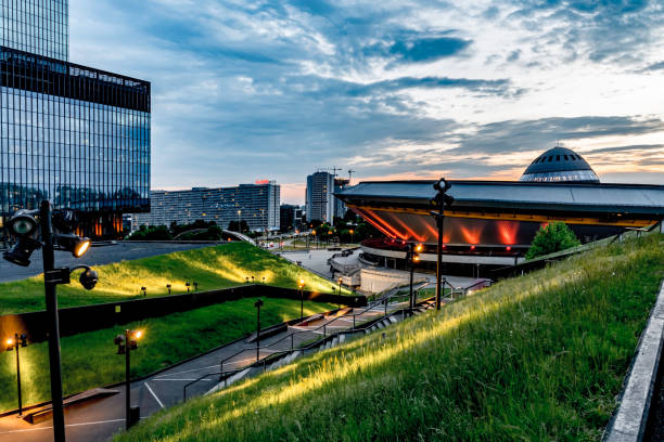 Spodek sports arena, famous landmark of Katowice city and green roof of International Congress Centre Katowice, Poland, June 2021: Spodek sports arena illuminated by evening lights, famous landmark of Katowice city and green roof of International Congress Centre katowice stock pictures, royalty-free photos & images