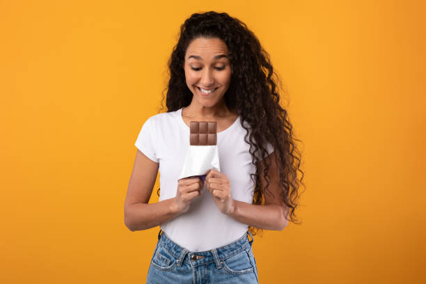 istock Funny Latin Lady Holding Chocolate At Studio 1368582391