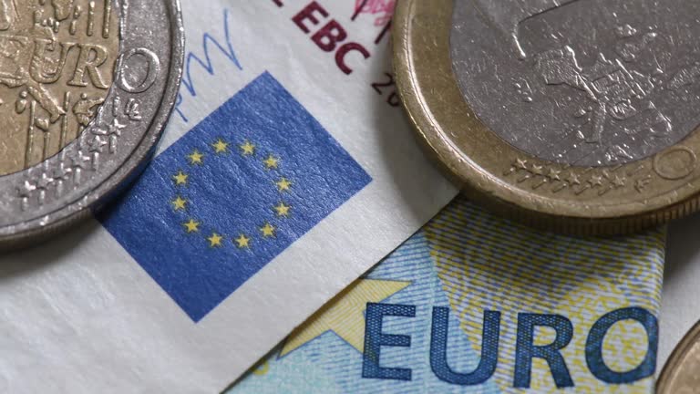 Details of euro cash : banknotes and coins in slow rotation