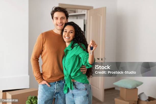 Happy Couple Showing Keys From Flat On Moving Day Stock Photo - Download Image Now - Home Ownership, Moving House, Couple - Relationship