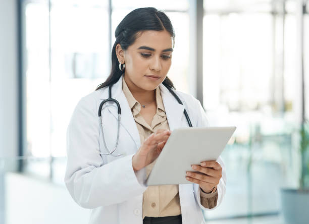 istock Shot of a doctor using a tablet in a hospital 1368588861
