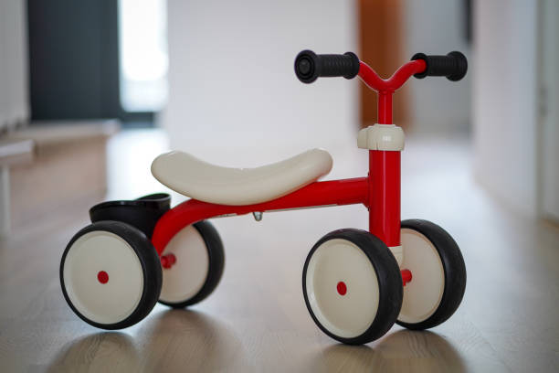istock Plastic red four wheeled child bicycle on the wooden floor 1368588973