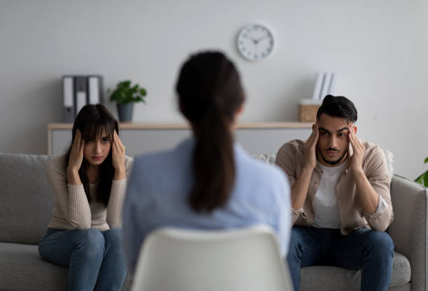 istock Back view of psychologist and young arab couple with relationship problems on background 1368589365