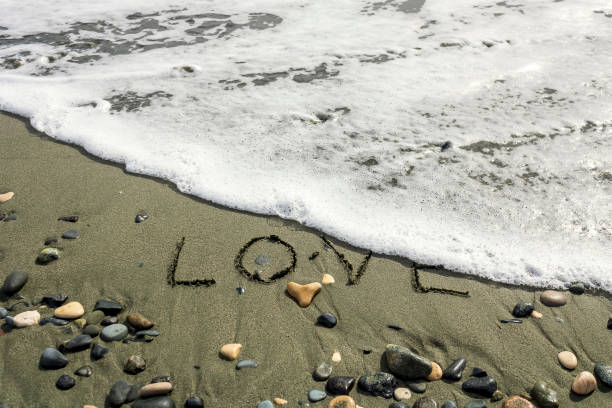 istock Wave erasing word Love on sea beach 1368590719