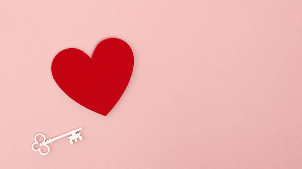 istock Bold red heart shape with white key on pastel pink background. Minimal concept for romantic valentine day with copy space. Love will set you free. 1368591897