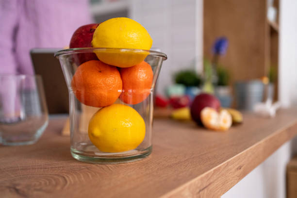 Lemon and orange in the fruit glass bowl