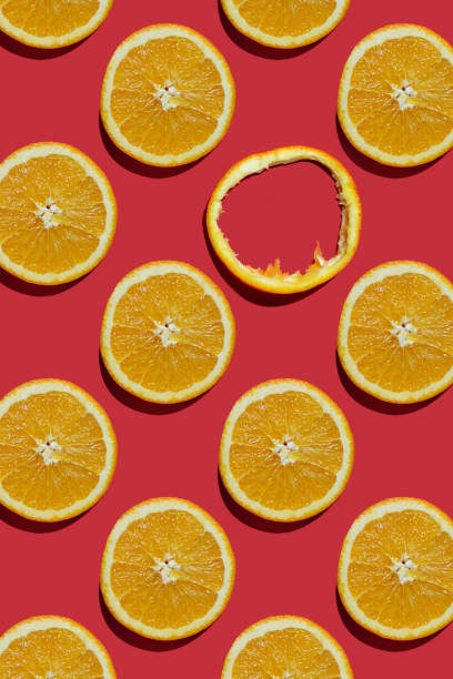 istock Summer composition made from oranges, on dark red  background. Creative Pattern made of slices of orange. Flat lay, top view of colorful fruit pattern of fresh orange slices on orange colorful background. 1368594915