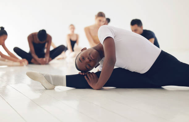 istock Shot of a group of ballerinas warming up before practicing their routine 1368596215