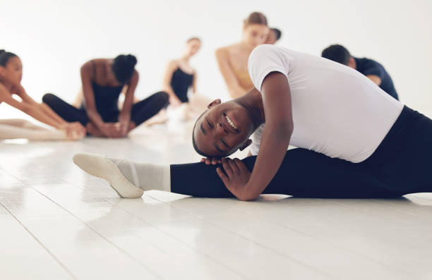 istock Shot of a group of ballerinas warming up before practicing their routine 1368596232