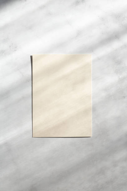 istock Blank paper sheet cards with sunlight shadows on stone background. Mockup scene with contrasting shadows 1368596291