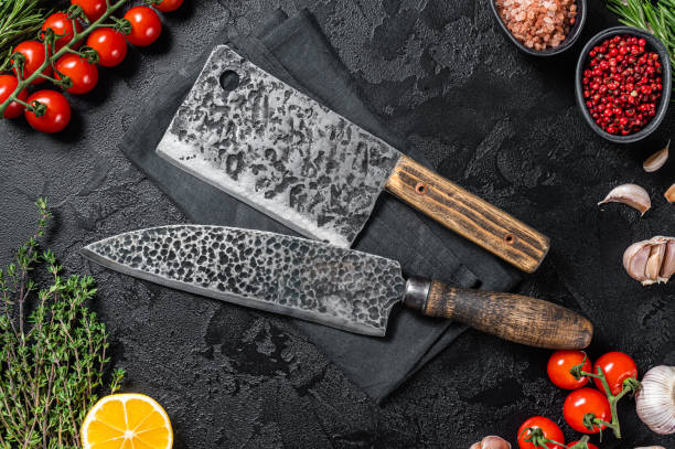 istock Rustic Cutting Board and Meat Cleaver on Dark  wooden board. Black background. Top view. Copy space 1368600454