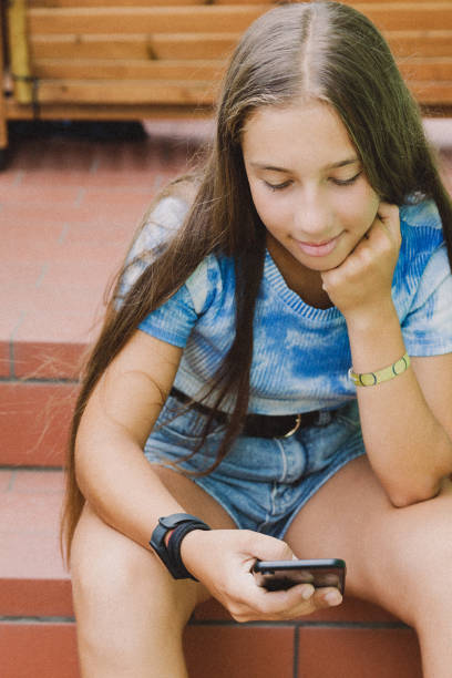 istock Pre-teen girl using phone 1368601282