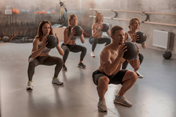 istock Professional trainer with his clients in gym 1368602951