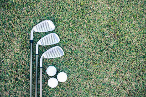 istock Different golf club on green grass background. sport concept. 1368603304