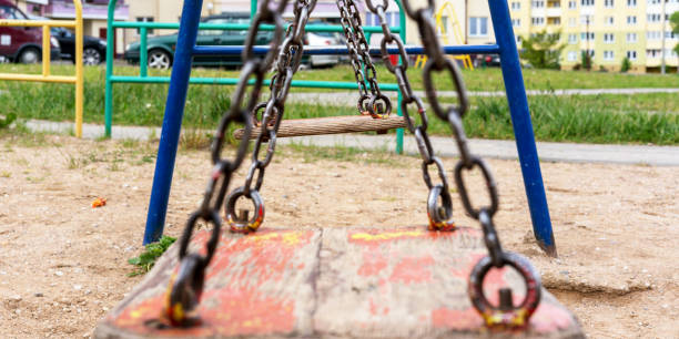istock old wooden swings on rusty metal chains on yard playground 1368604278