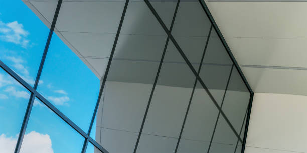 istock large panoramic windows of local building reflect blue sky 1368604320