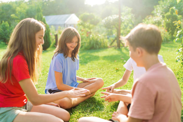 istock Group of children playing hand game in backyard 1368605235