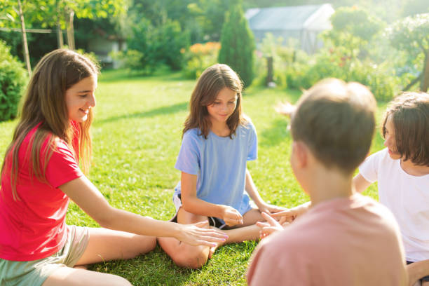 istock Group of children playing hand game in backyard 1368605243