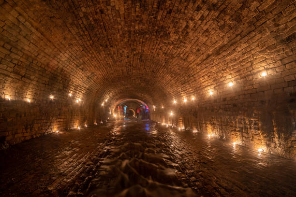 Ancient brick underground rain collector, lit by candles.