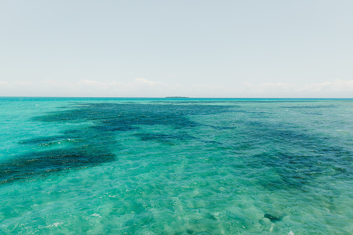 Scenic view of the crystal turquoise ocean with coral reef and the small island on Zanzibar, Tanzania