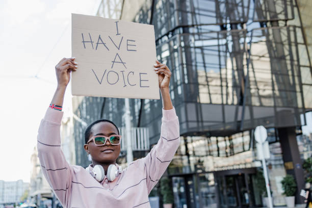 istock Woman on the street, protesting against racism 1368611007