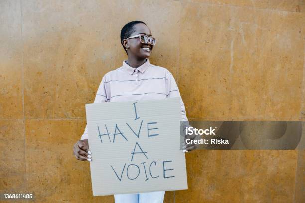 Portrait Of Woman Holding Anti Racism Sign Stock Photo - Download Image Now - Protest, Women, Black People