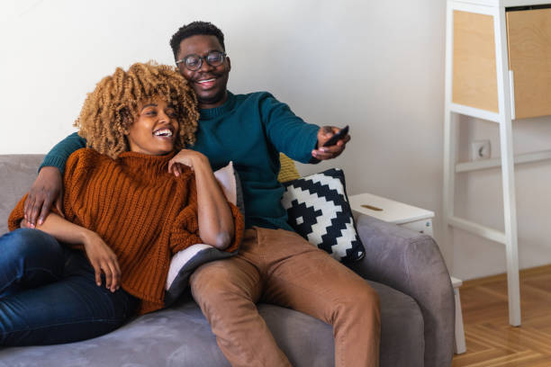 istock The couple is relaxing on the sofa and watching tv 1368612857