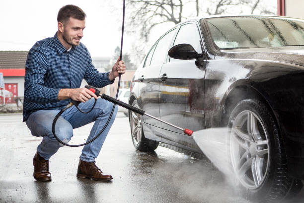 istock Young man washing his car 1368612950