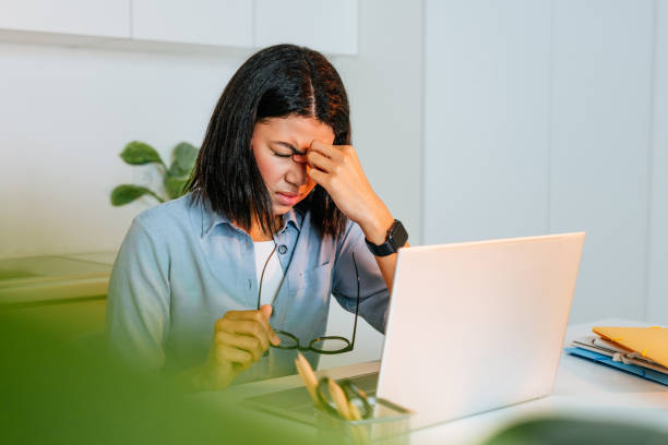 istock Young beautiful woman working using laptop feeling overworked 1368613088