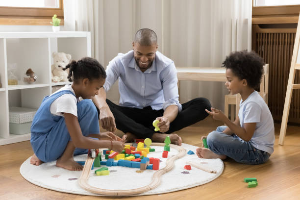 istock Happy dad and two kids playing games on heating floor 1368613325