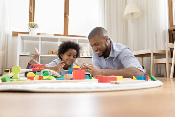 istock Happy dad and preschool boy lying on clean heating floor 1368613328
