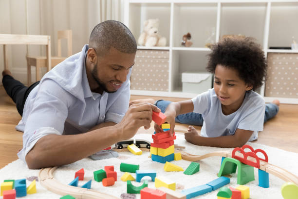 istock Loving dad and son engaged in game with construction cubes 1368613330