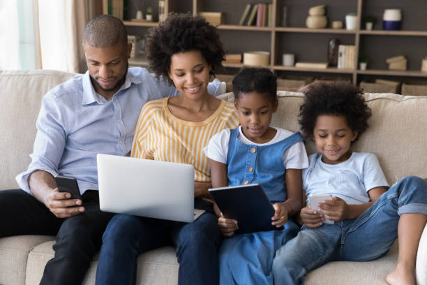 istock African American family engaged in digital gadgets using 1368613366